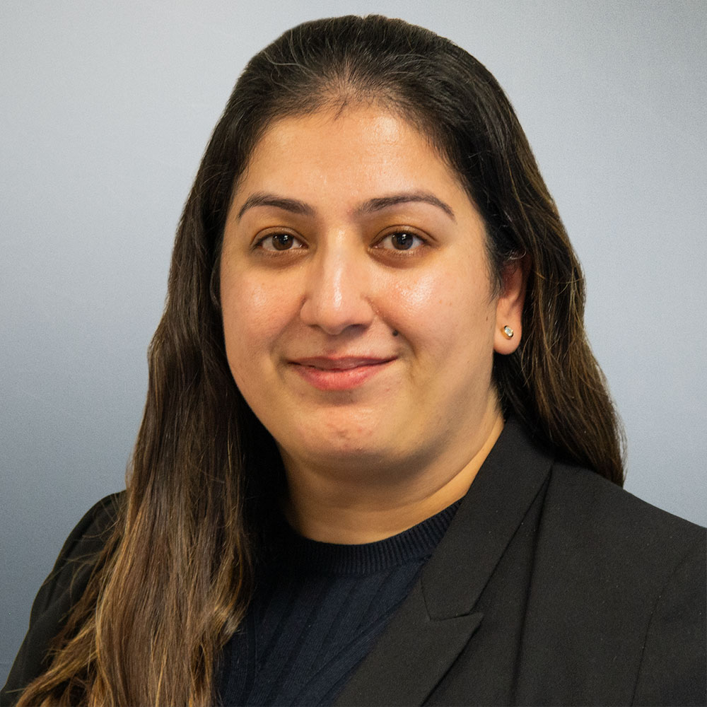 Monica Guram, Solicitor in Flint Bishop’s Commercial Dispute Resolution team, smiling in professional headshot